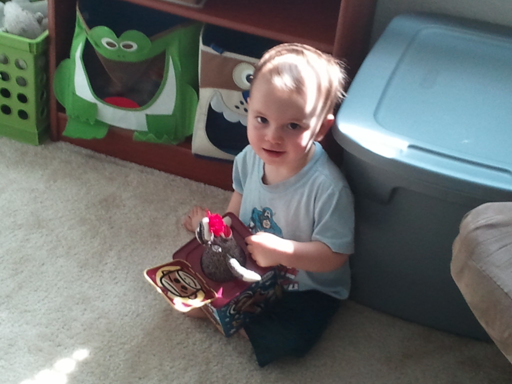 Playing with his monkey jack-in-the-box