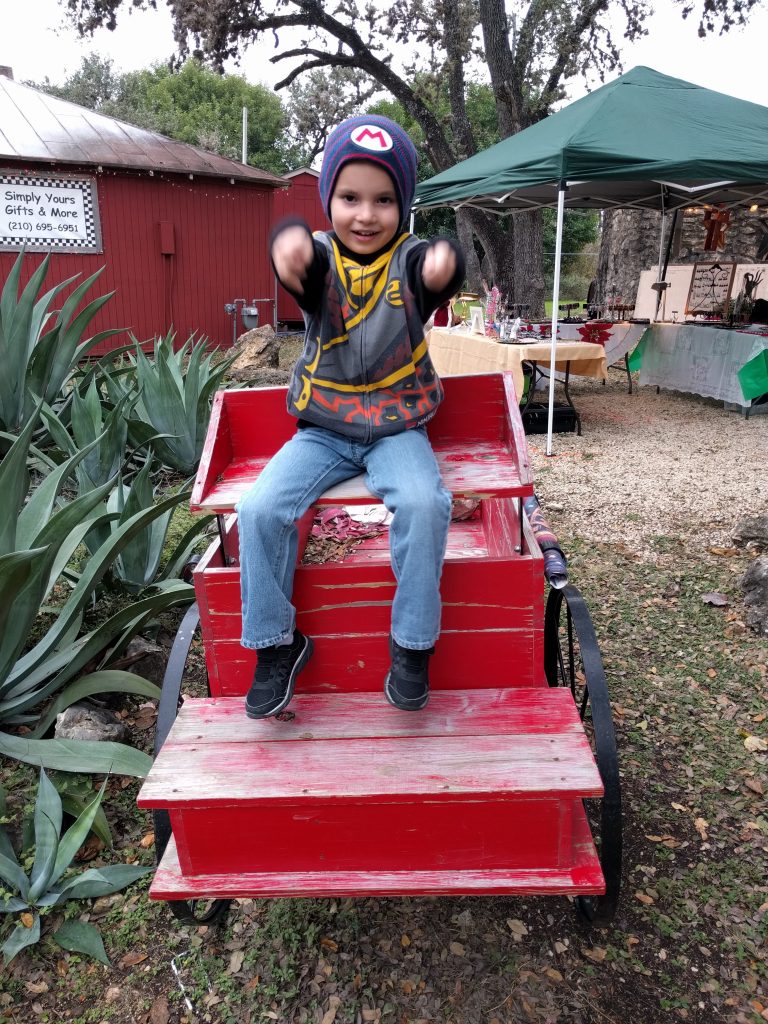 "Driving" the wagon in Old Town Helotes while at the craft fair with Paul. 
